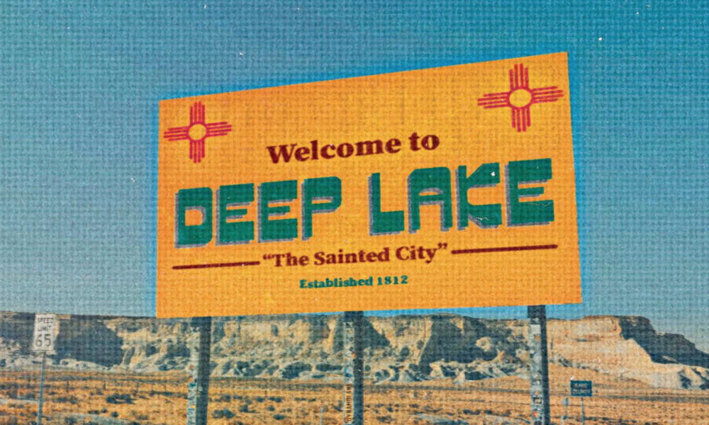 A yellow sign in a new mexico landscape that reads, "Welcome to Deep Lake, The Sainted City. Established 1812" Welcome to and The Sainted City are written in red and Deep Lake and Established in 1812 are written in a darker turquoise. There are two red crosslike symbols in the upper left and right hand part of the sign. In the landscape is a messa in front of desert scrub land. Closer to the fore ground near the sign is a 65 MPH speed limit sign. The sky is bright blue. The image looks as if it's been stamped with a blank cross stitch pattern.